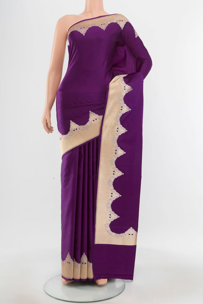 Pure Silk Pure Zari Violet Banarasi Saree with Zari Butta on the body and Silk Border.  displayed on a mannequin