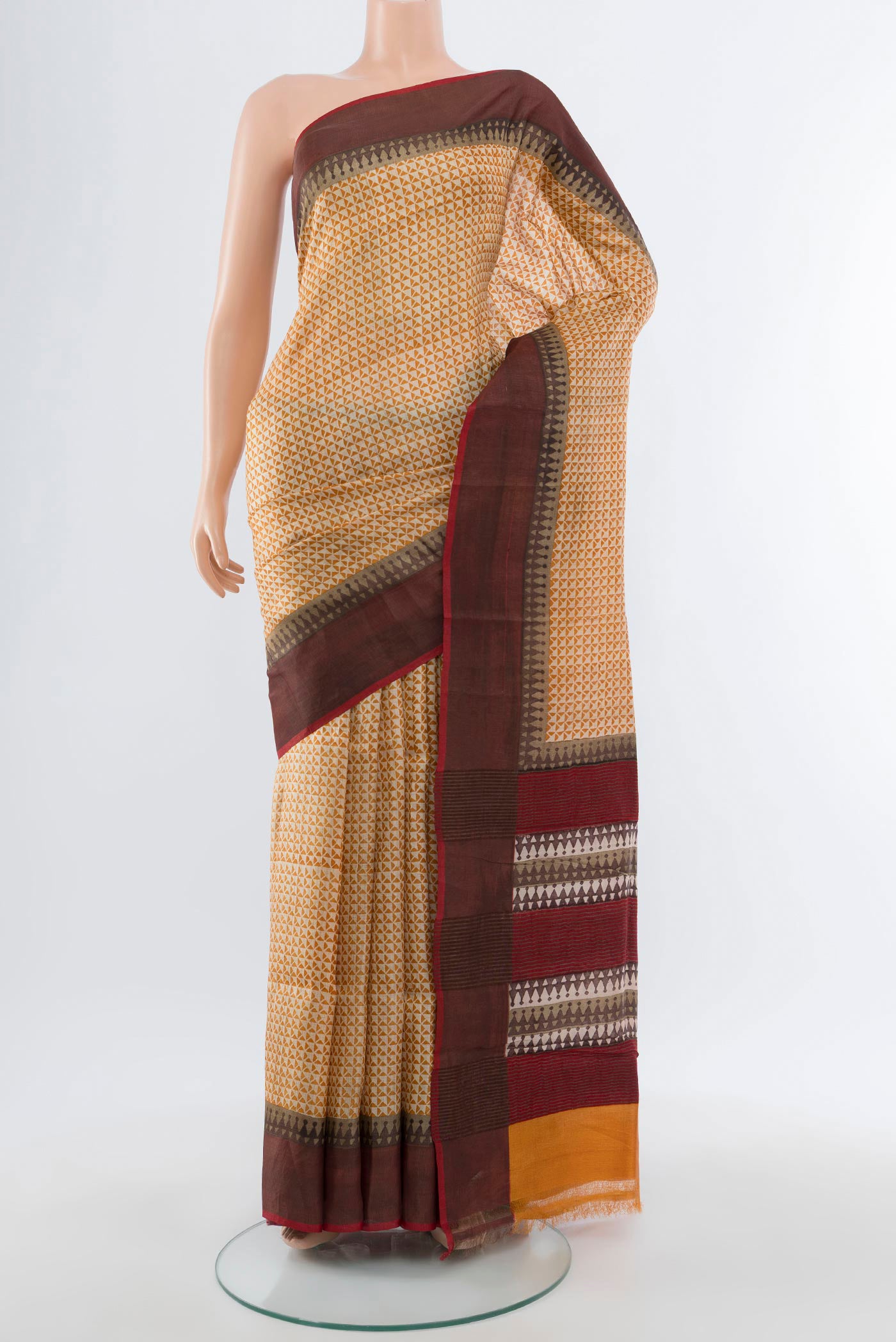 Beige Tussar Silk Saree with Printed design on the body and Zari Border.  displayed on a mannequin
