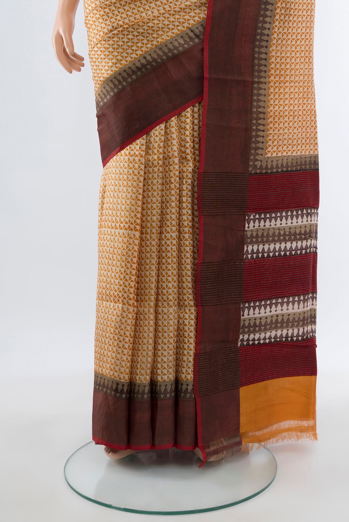 Pleats and pallu of Beige Tussar Silk Saree with Printed design on the body and Zari Border. 