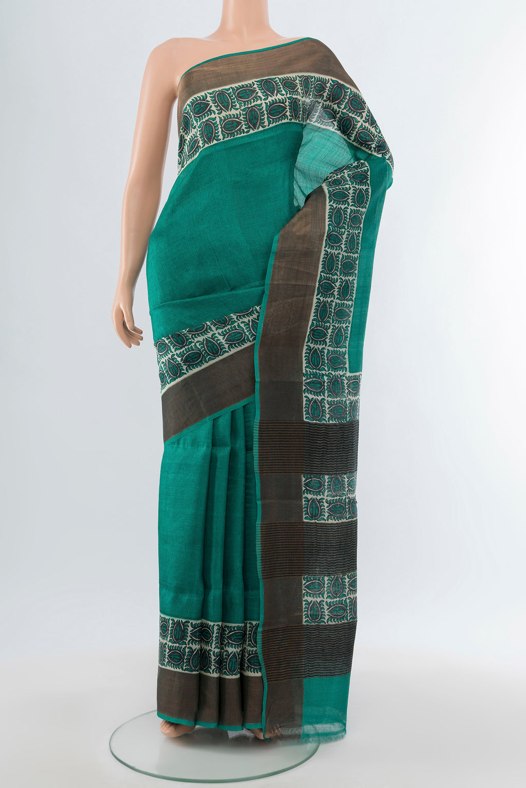 Peacock Blue Tussar Silk Saree with Floral Print on the body and Silk Border.  displayed on a mannequin