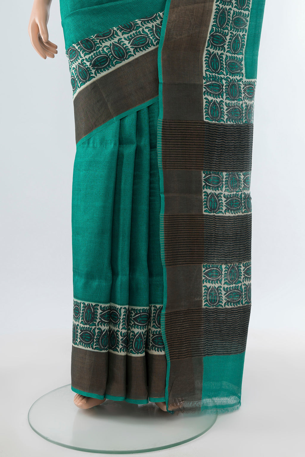 Pleats and pallu of Peacock Blue Tussar Silk Saree with Floral Print on the body and Silk Border. 