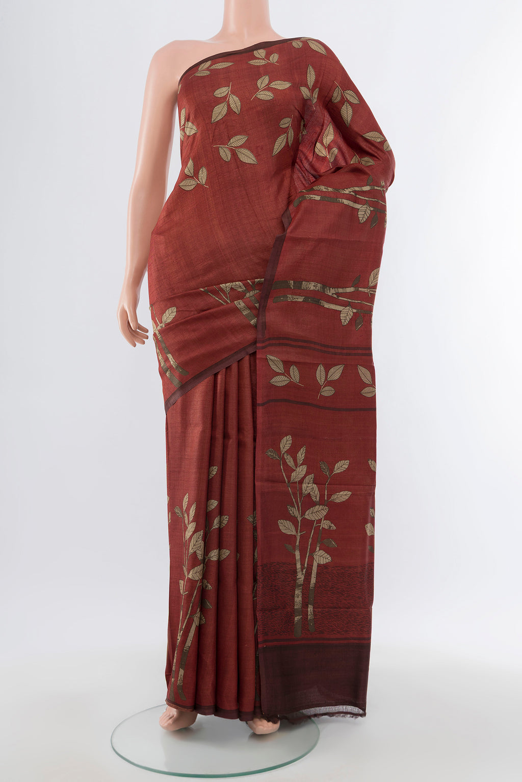 Brown Tussar Silk Saree with Floral Print on the body and Silk Border.  displayed on a mannequin