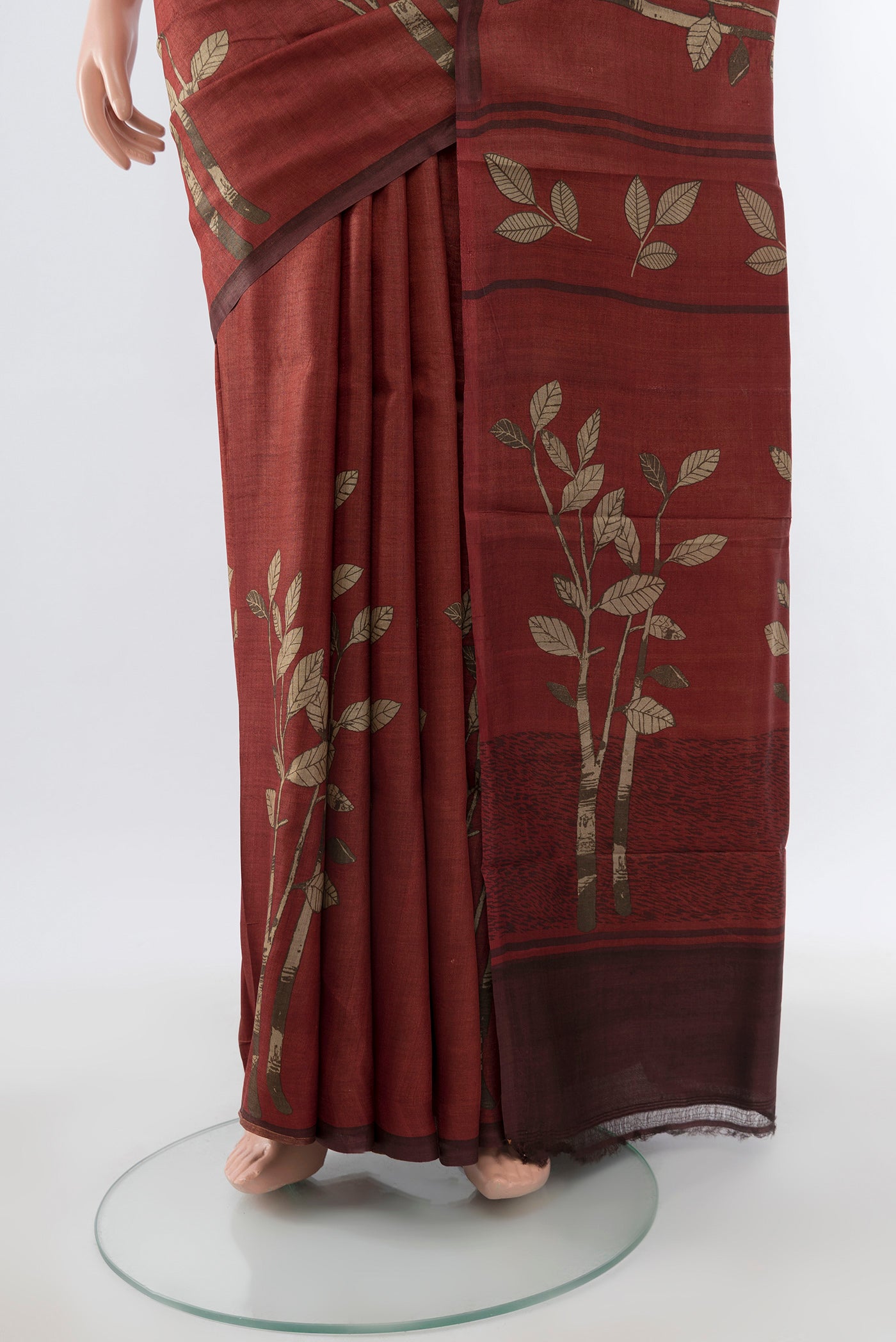 Pleats and pallu of Brown Tussar Silk Saree with Floral Print on the body and Silk Border. 