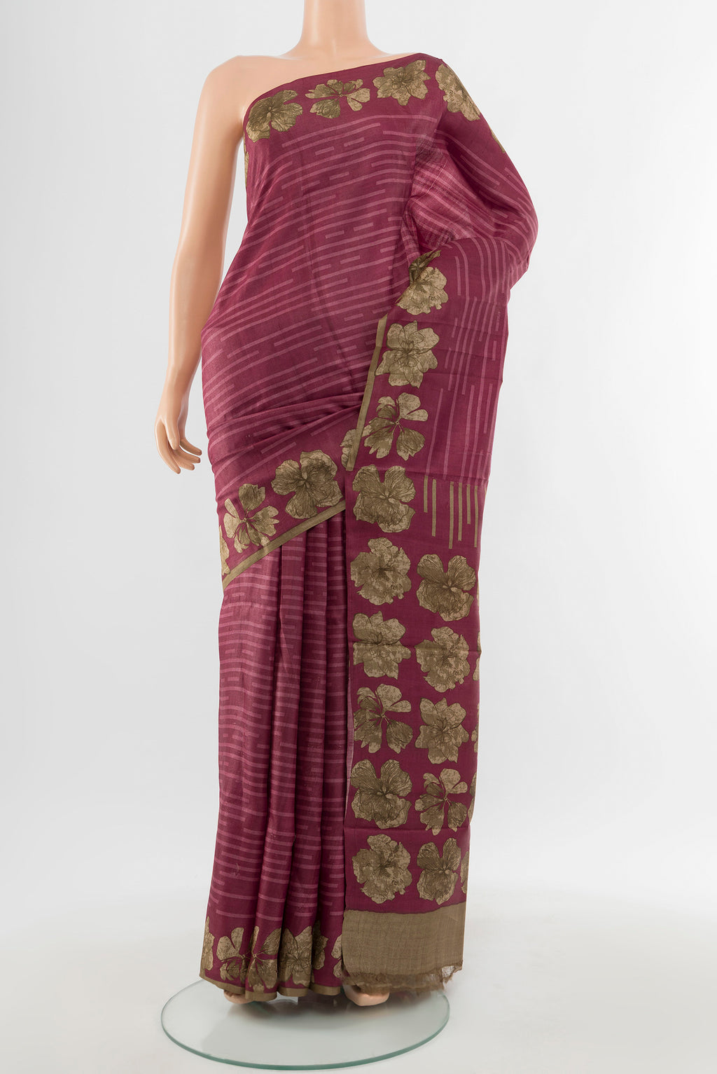 Bronze Tussar Silk Saree with Floral Print on the body and Silk Border.  displayed on a mannequin