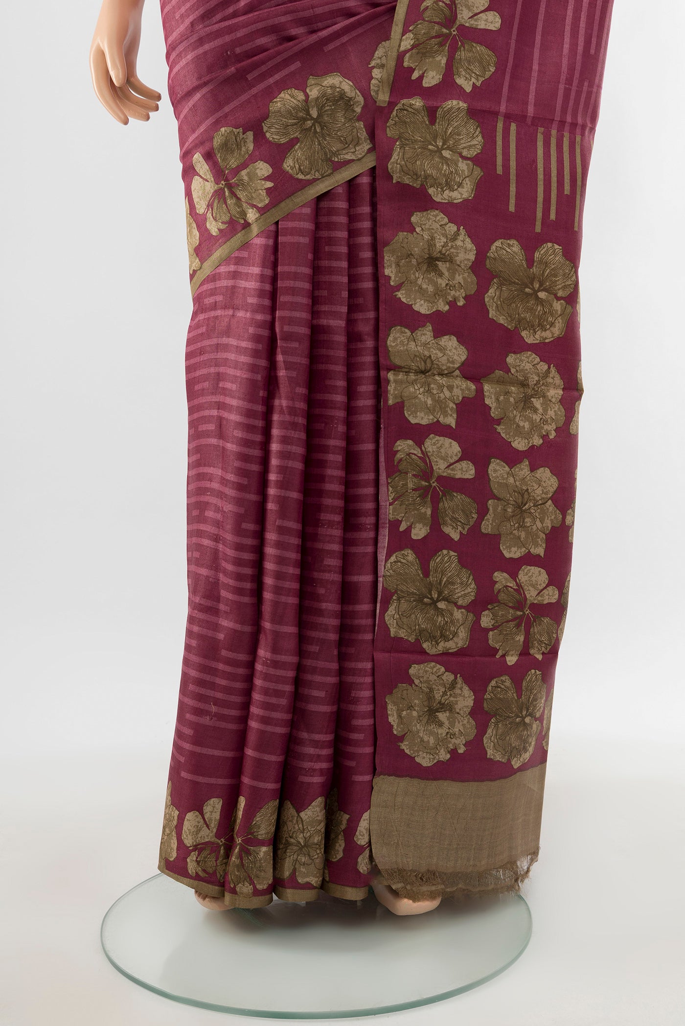 Pleats and pallu of Bronze Tussar Silk Saree with Floral Print on the body and Silk Border. 