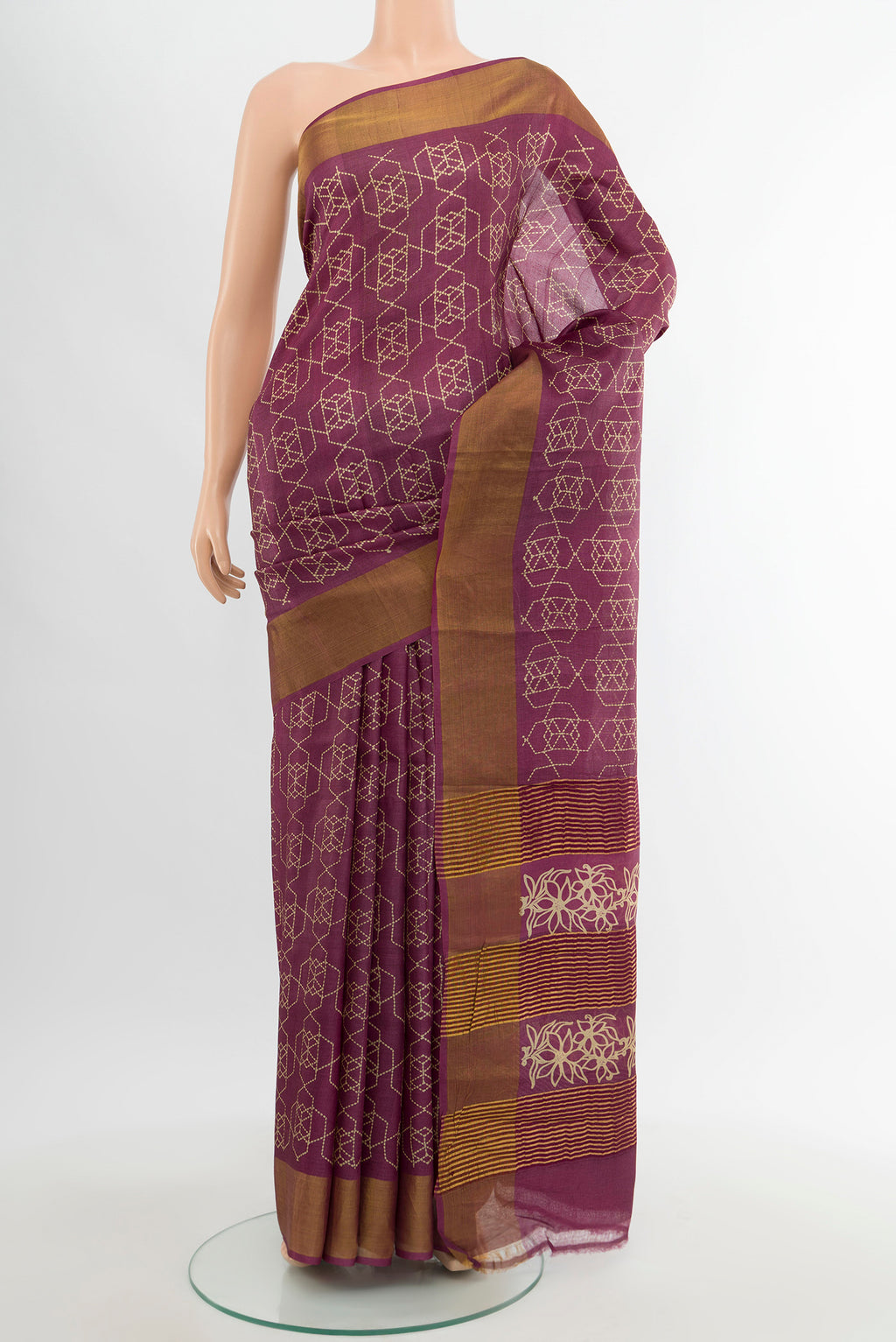 Magenta Tussar Silk Saree with Floral Print on the body and Zari Border.  displayed on a mannequin
