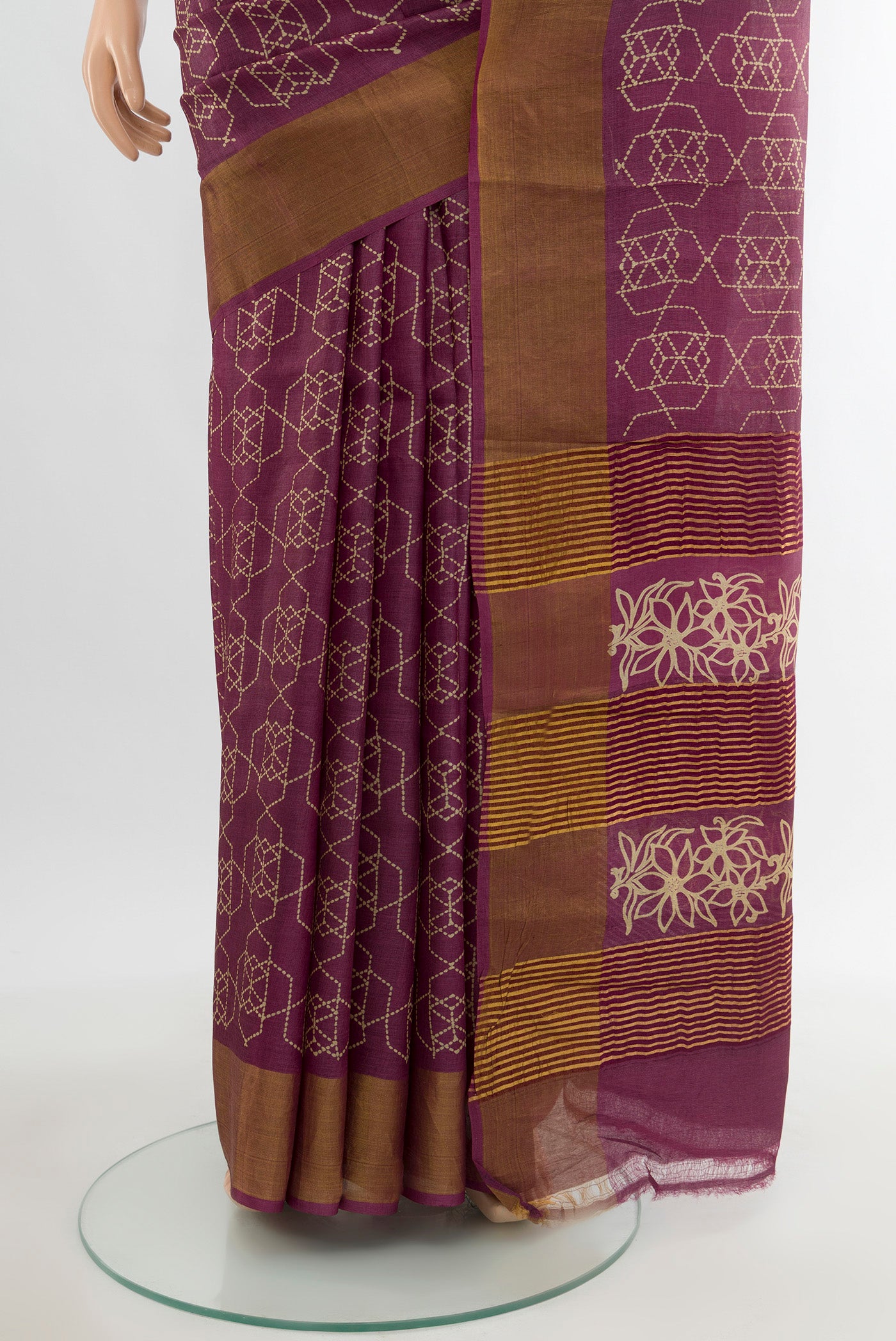 Pleats and pallu of Magenta Tussar Silk Saree with Floral Print on the body and Zari Border. 