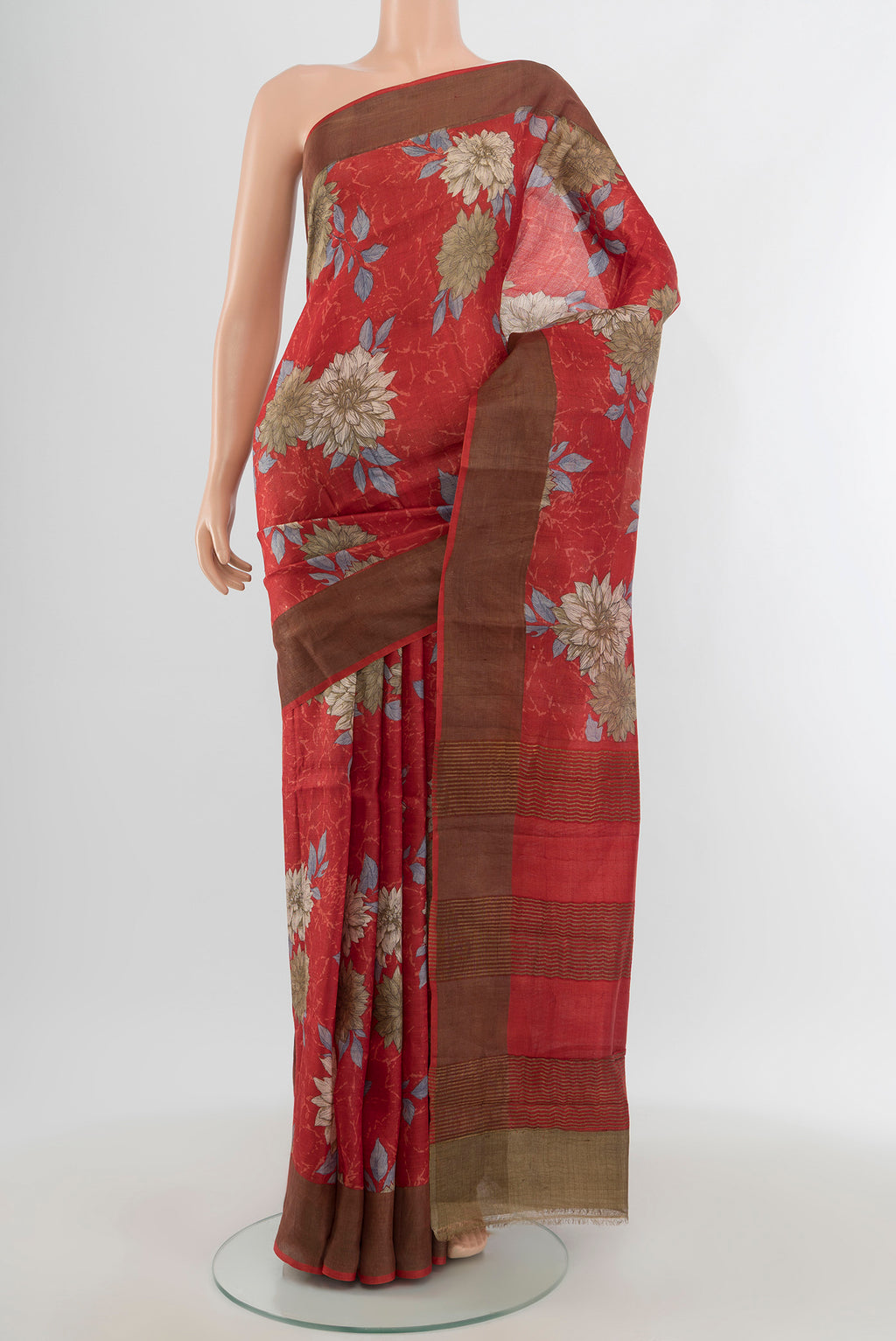 Red Tussar Silk Saree with Floral Print on the body and Zari Border.  displayed on a mannequin
