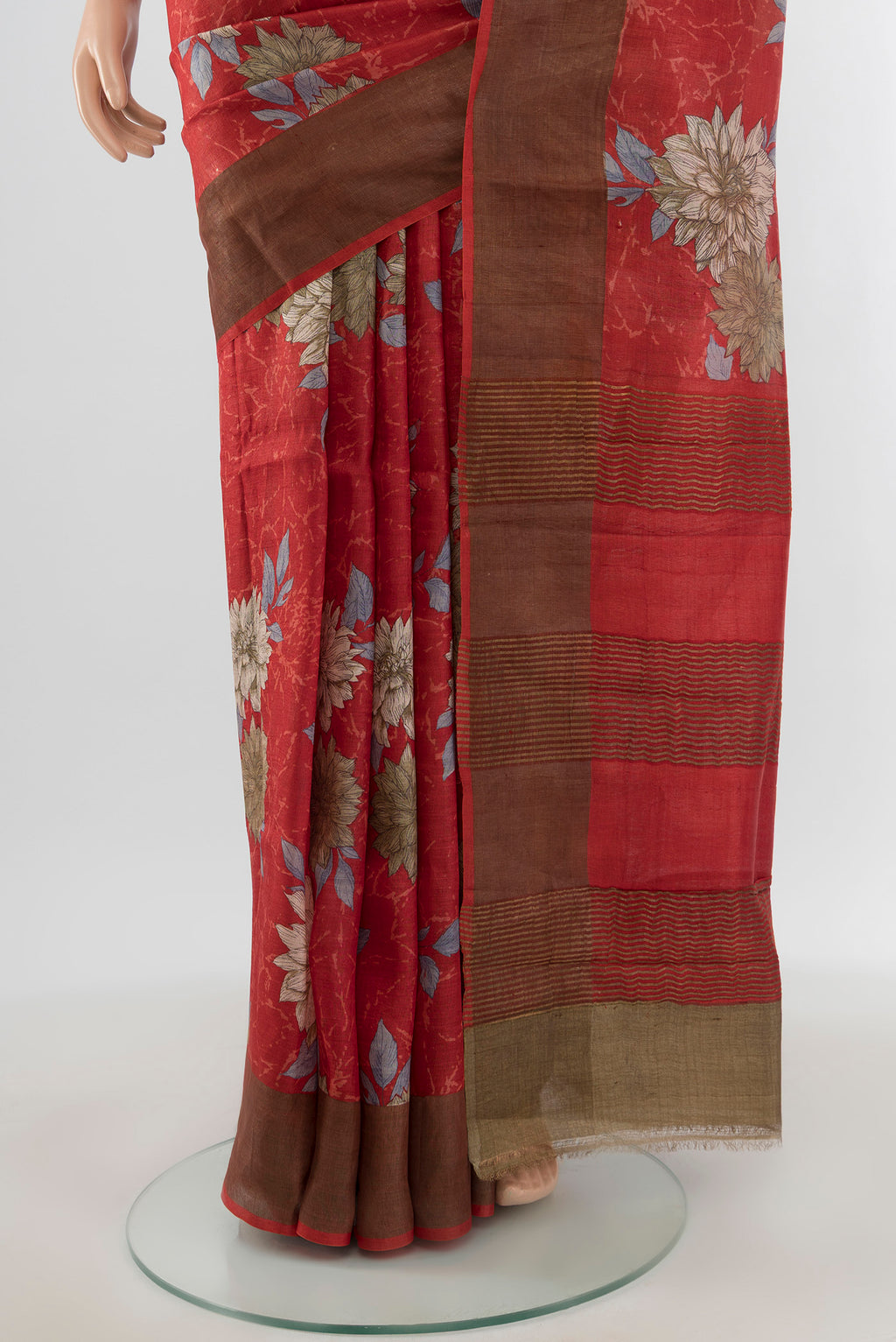 Pleats and pallu of Red Tussar Silk Saree with Floral Print on the body and Zari Border. 