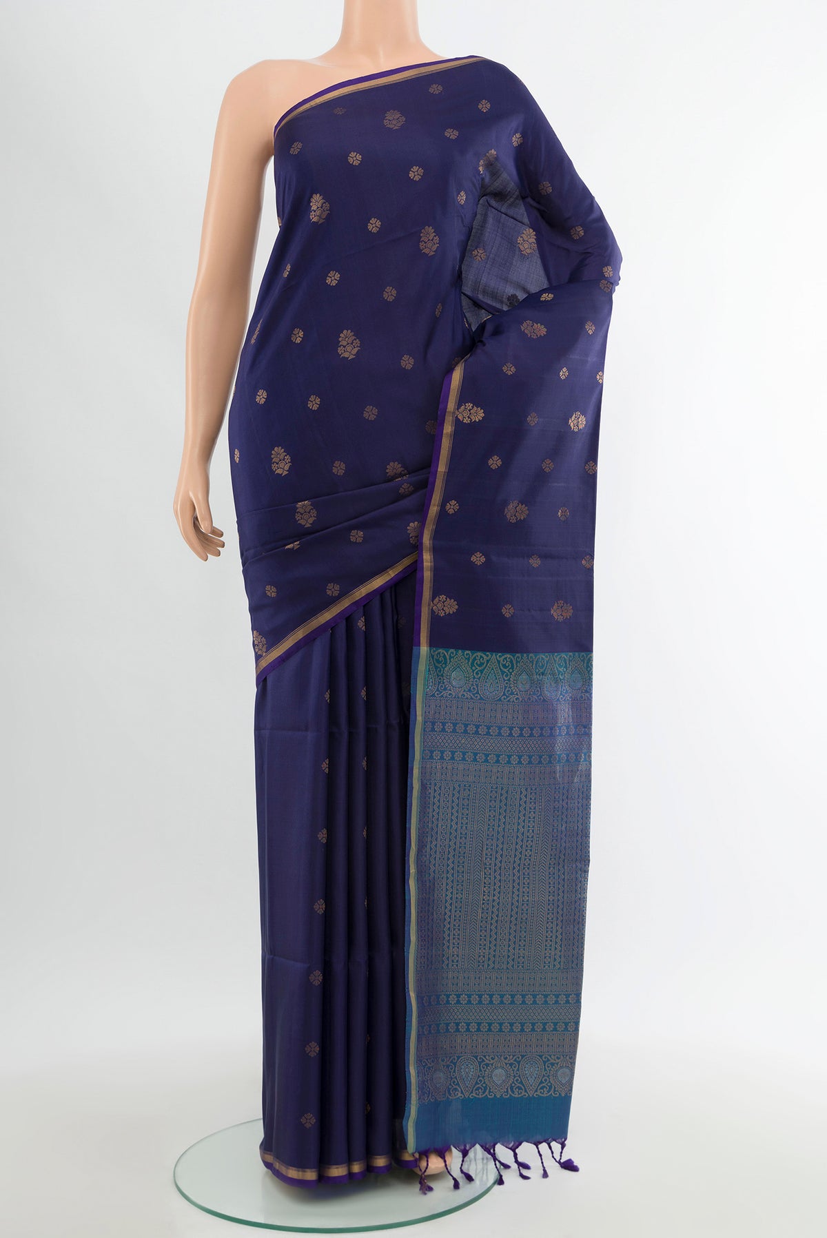 Navy Blue Soft Silk Saree with Zari Butta on the body and Zari Border.  displayed on a mannequin