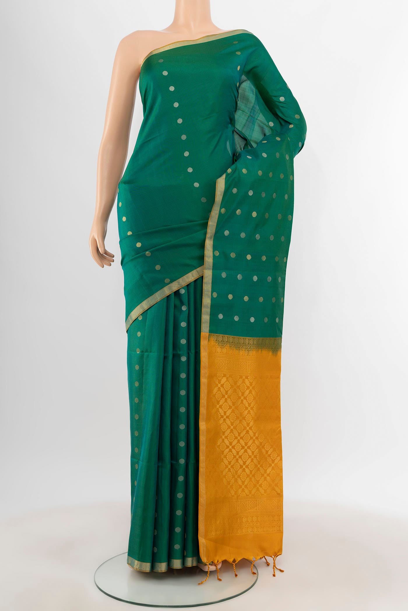 Green Soft Silk Saree with Zari Butta on the body and Zari Border.  displayed on a mannequin