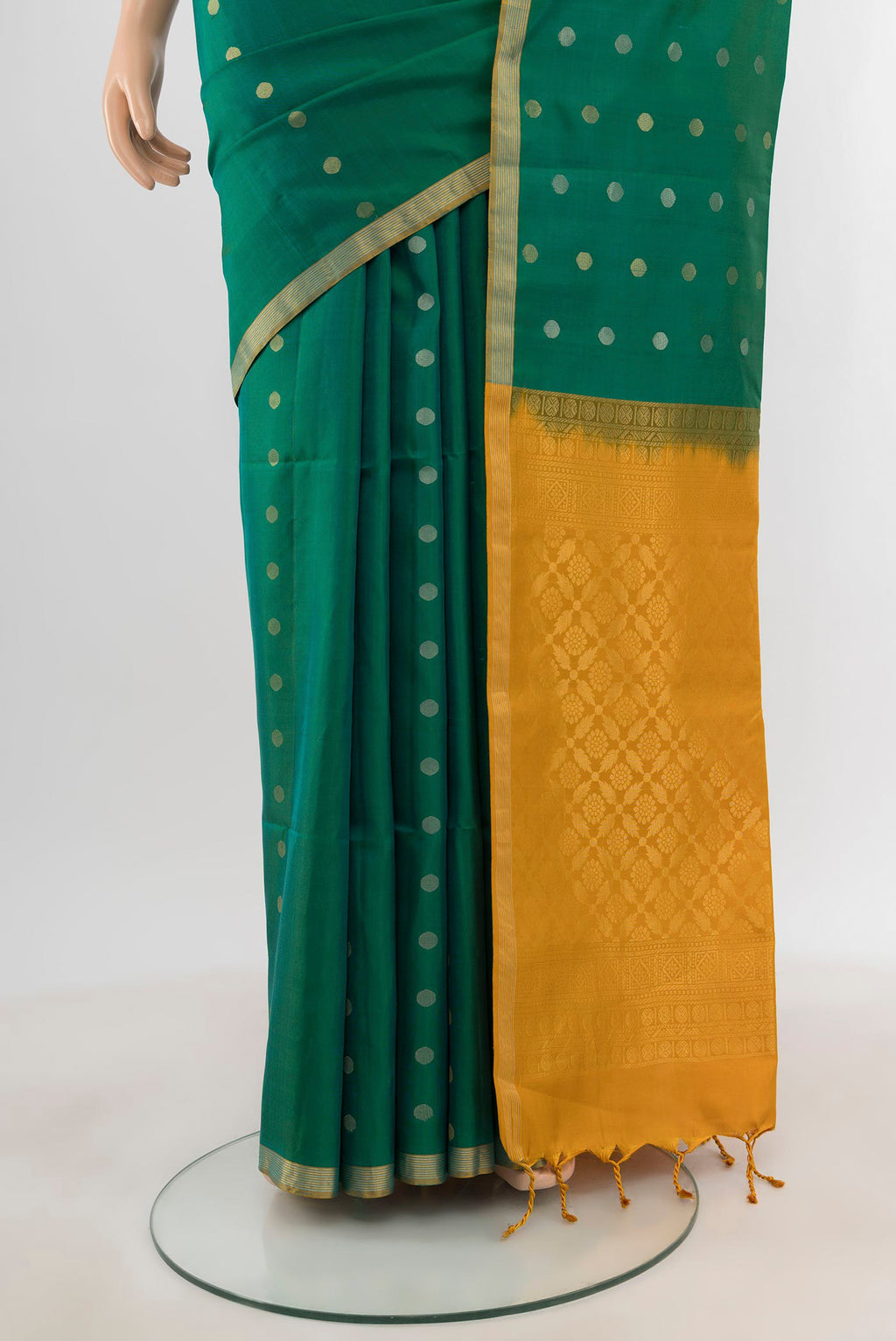 Pleats and pallu of Green Soft Silk Saree with Zari Butta on the body and Zari Border. 
