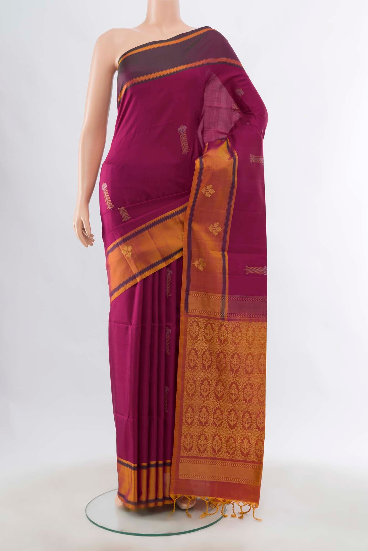Magenta Soft Silk Saree with Zari Butta on the body and Plain Border displayed on a mannequin