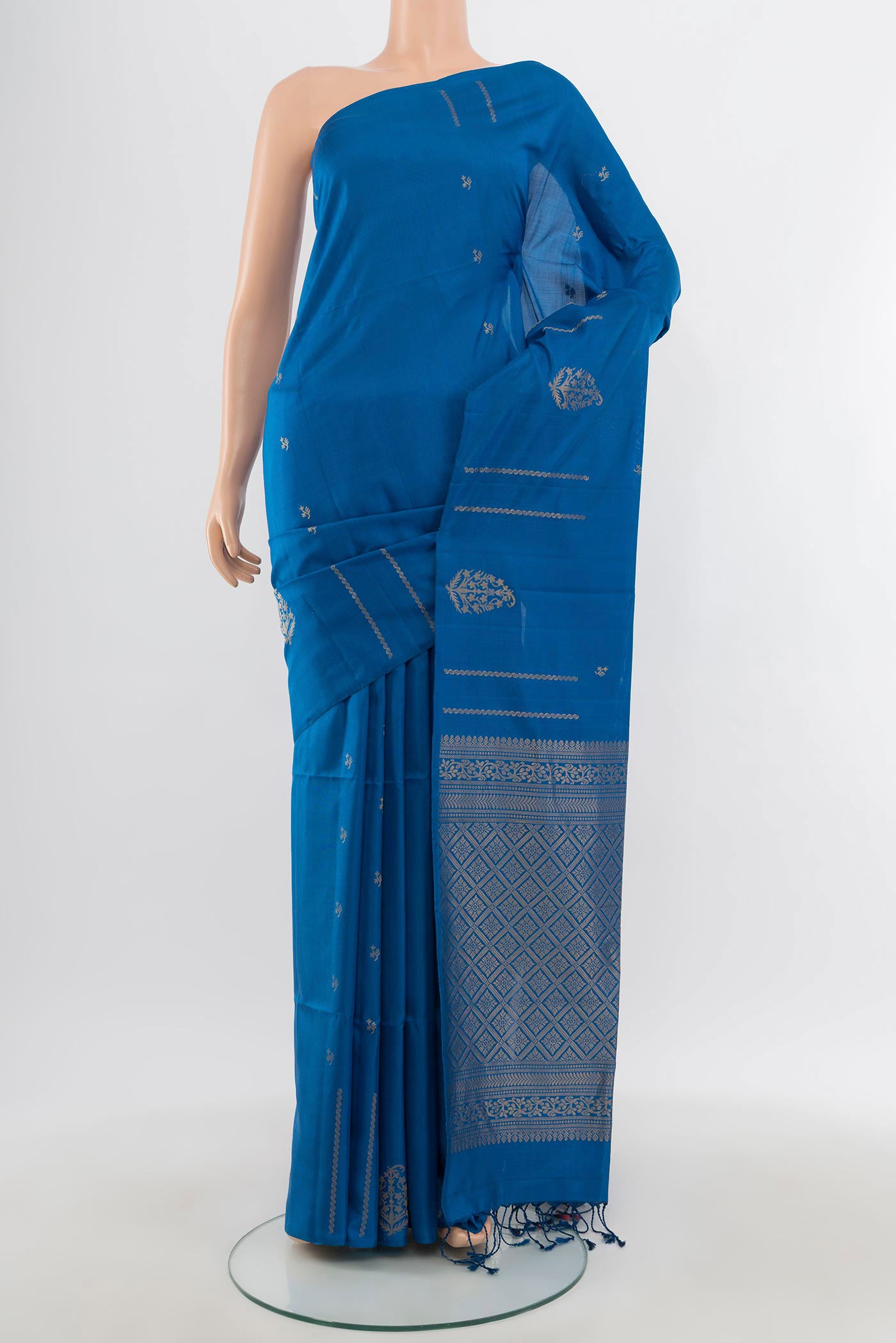 Blue Soft Silk Saree with Zari Butta on the body and Without Border.  displayed on a mannequin