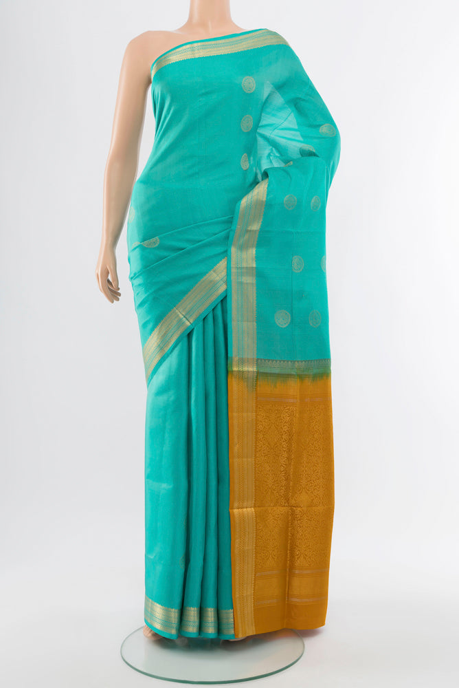 Sky Blue Soft Silk Saree with Zari Butta on the body and Silk Border.  displayed on a mannequin