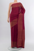 Maroon Soft Silk Saree with Zari Butta on the body and Silk Border.  displayed on a mannequin