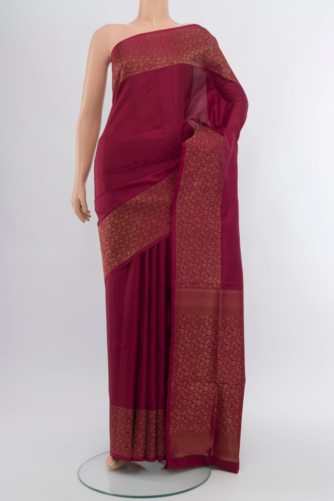 Maroon Soft Silk Saree with Zari Butta on the body and Silk Border.  displayed on a mannequin
