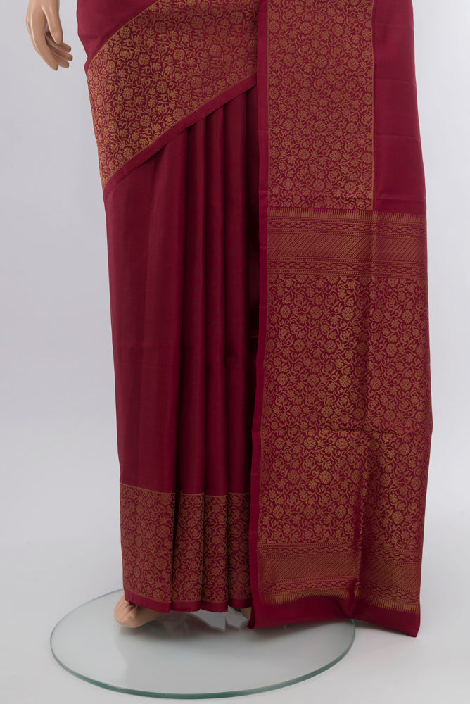 Pleats and pallu of Maroon Soft Silk Saree with Zari Butta on the body and Silk Border. 