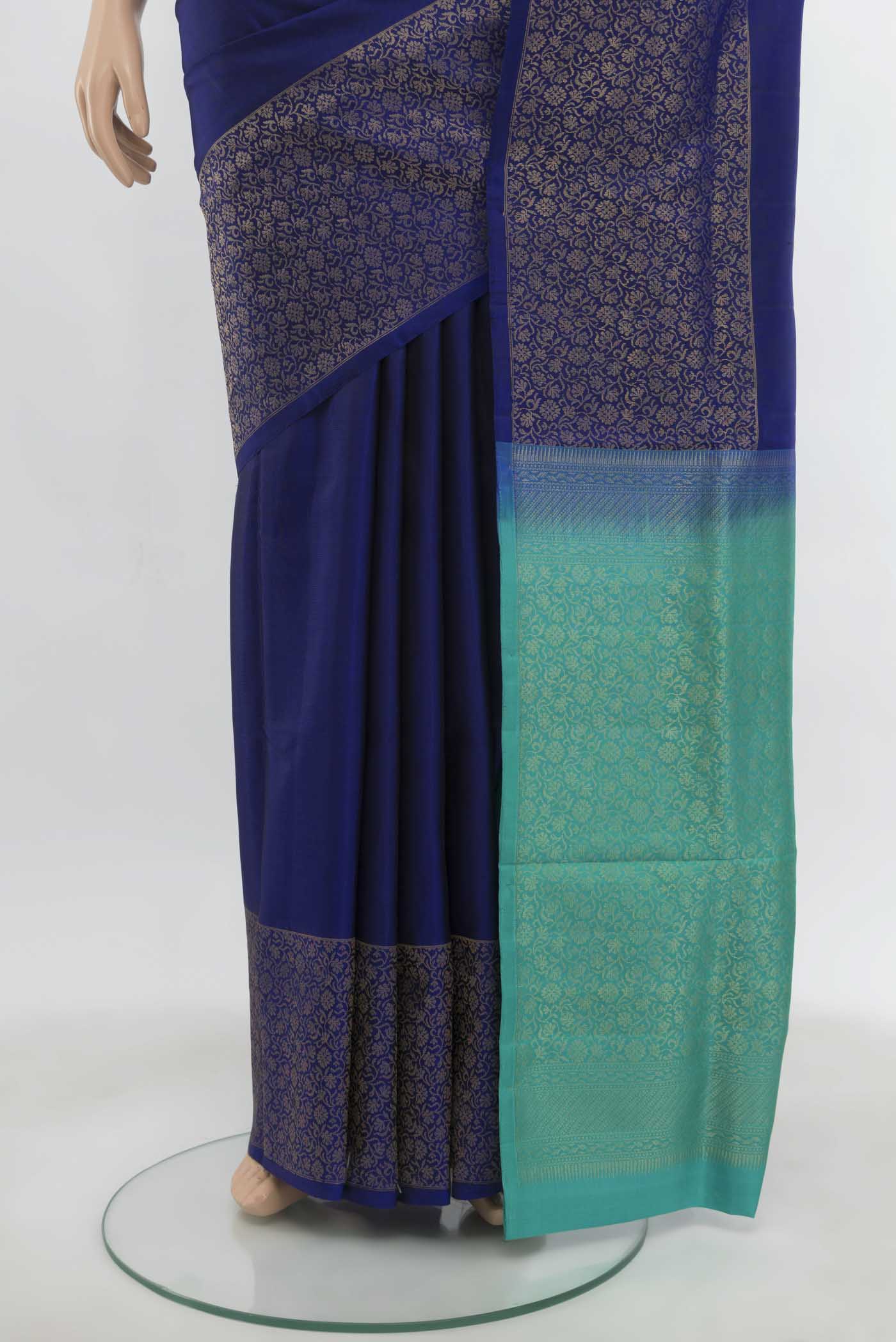 Pleats and pallu of Navy Blue Soft Silk Saree with Zari Butta on the body and Zari Border. 