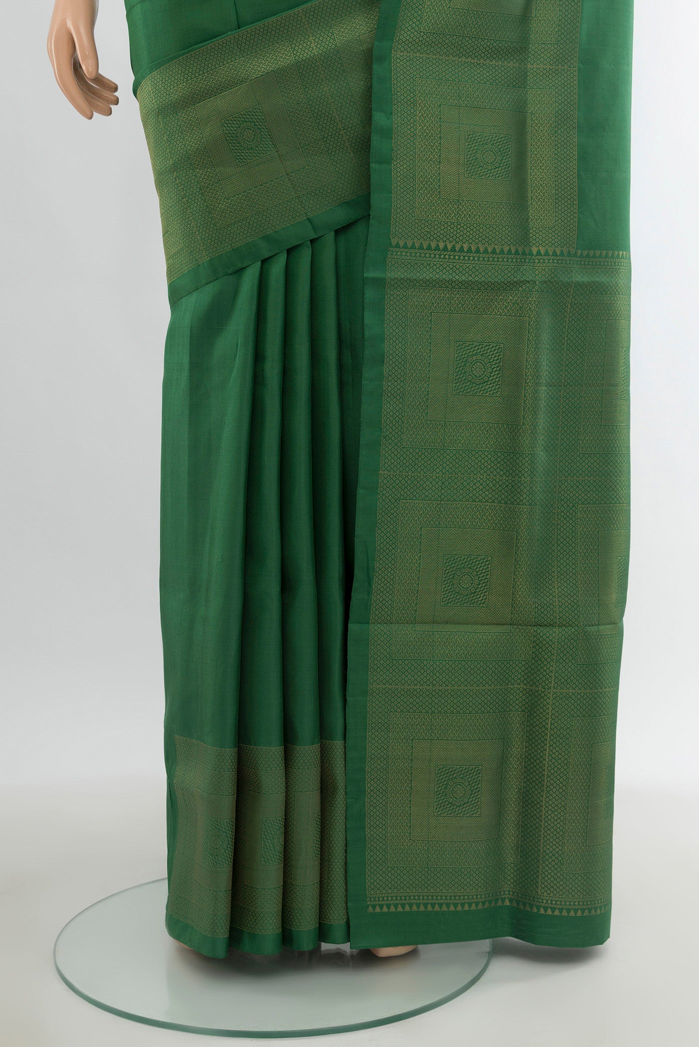 Pleats and pallu of Green Soft Silk Saree with Plain Body and Zari Border. 