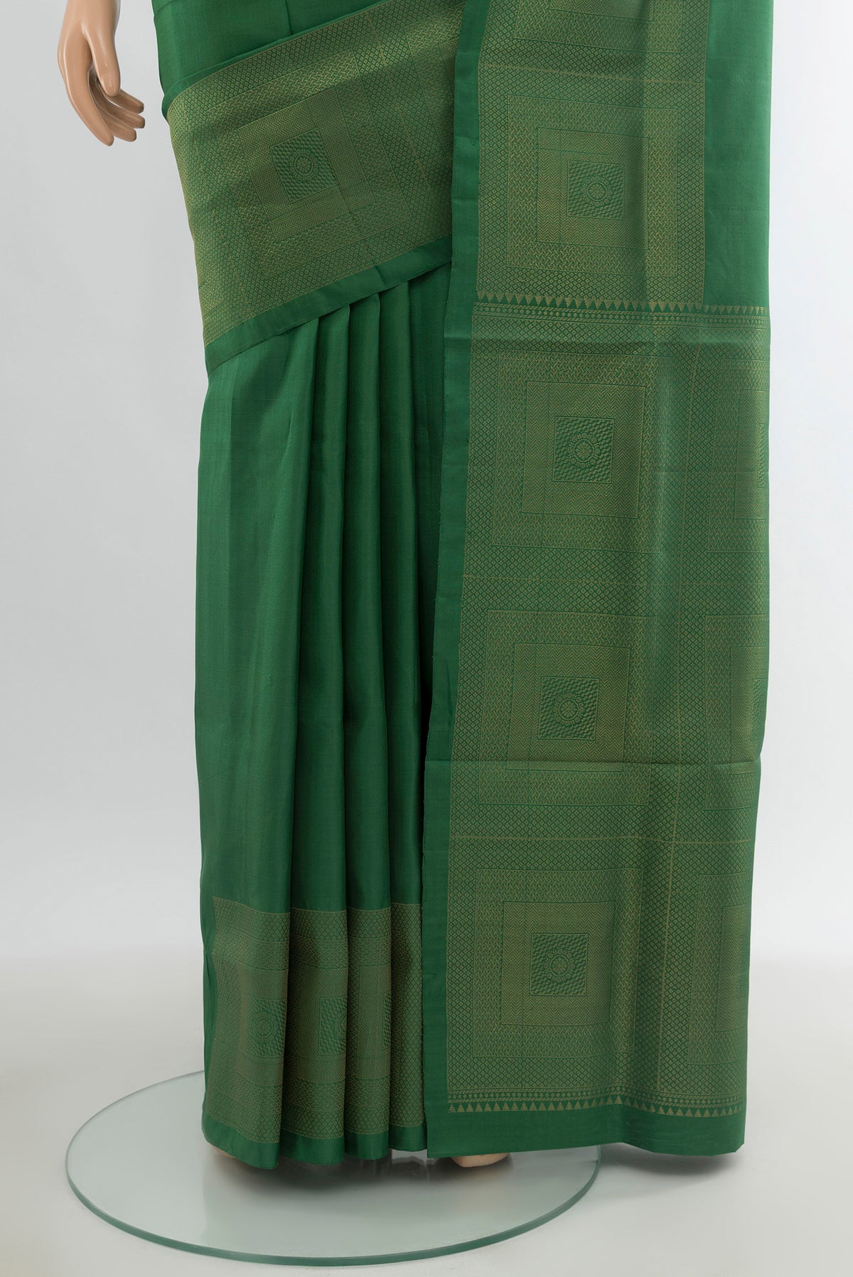 Pleats and pallu of Green Soft Silk Saree with Plain Body and Zari Border. 