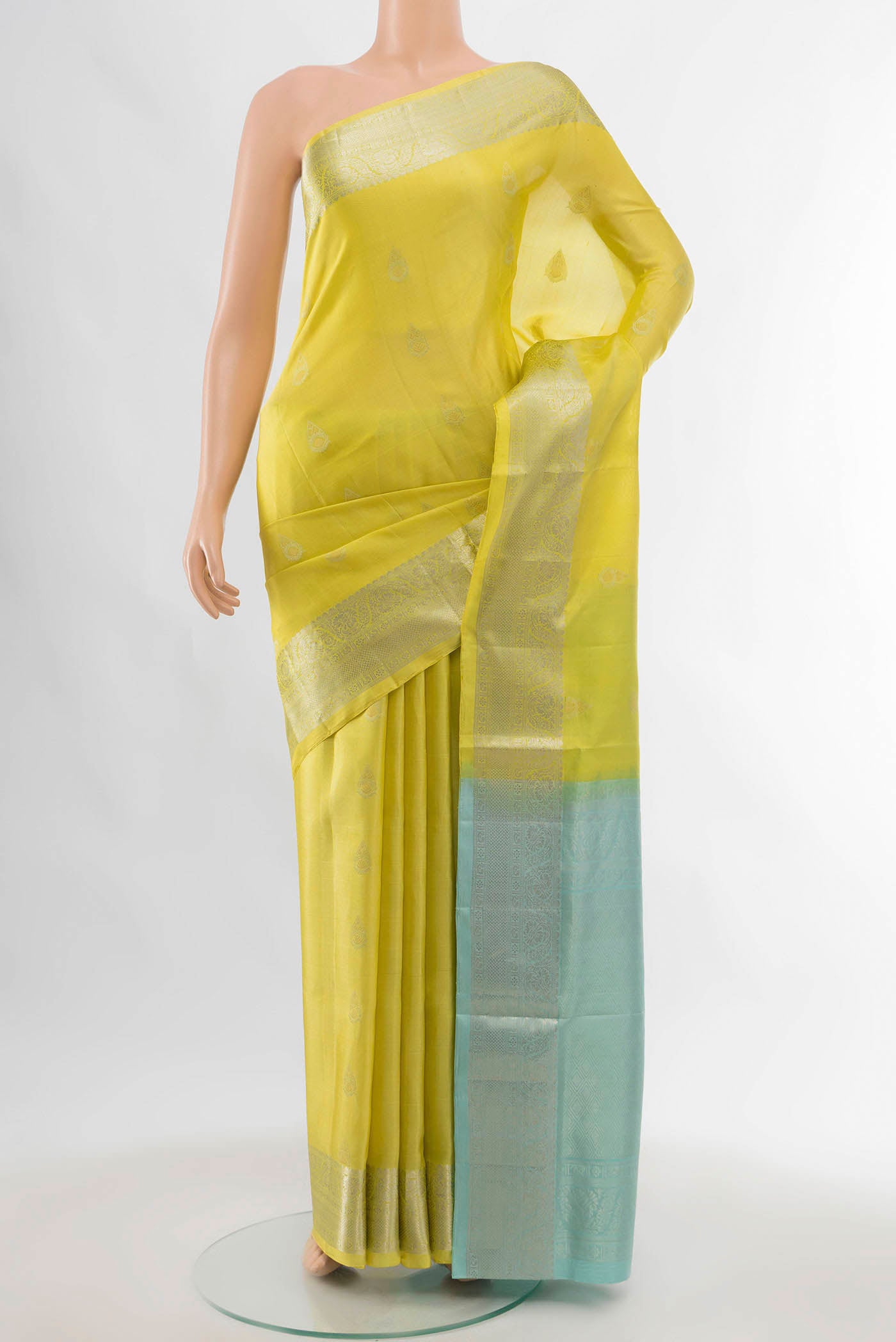 Lemon Yellow Soft Silk Saree with Zari Butta on the body and Zari Border displayed on a mannequin