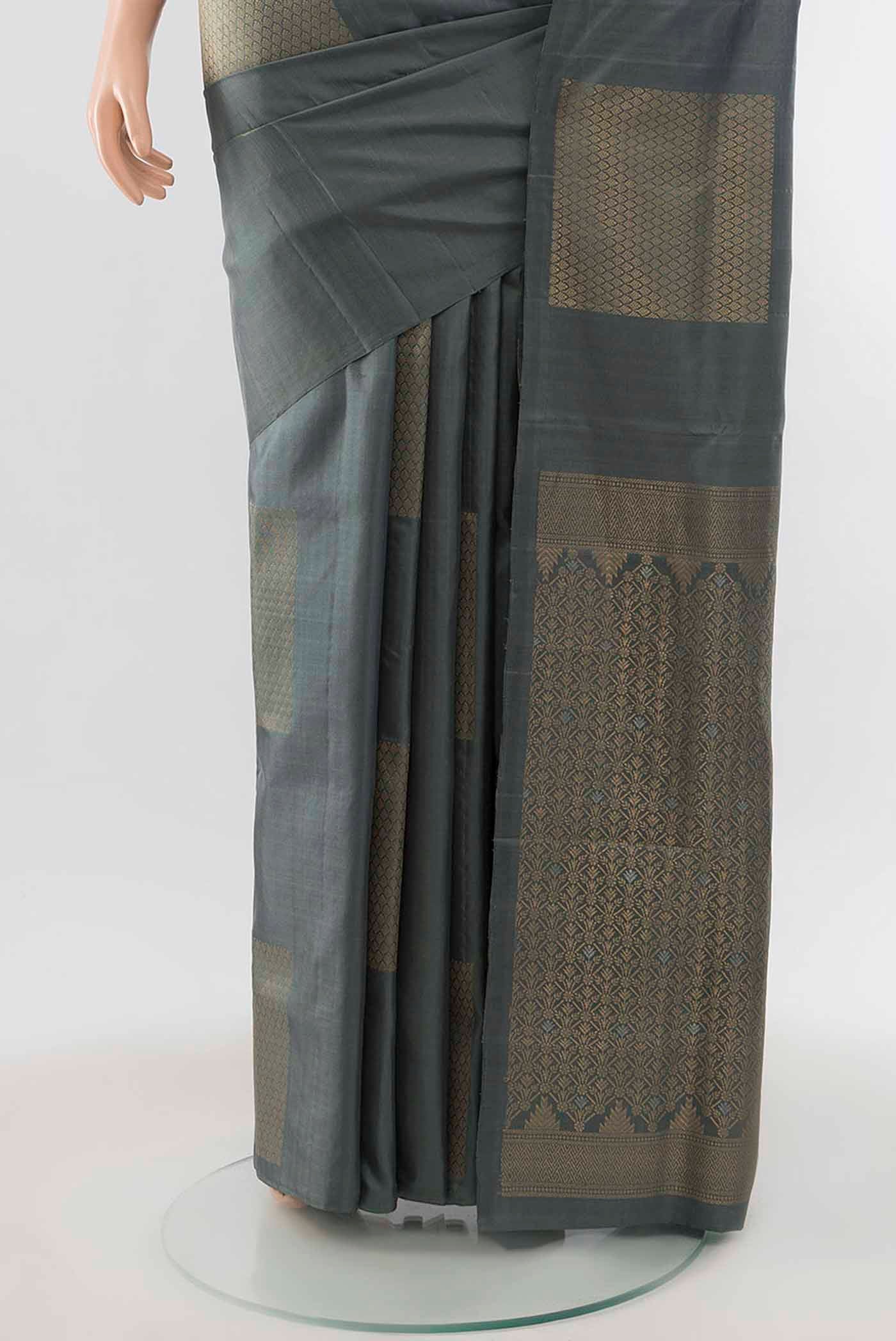 Pleats and pallu of Grey Soft Silk Saree with Zari Butta on the body and Zari Border