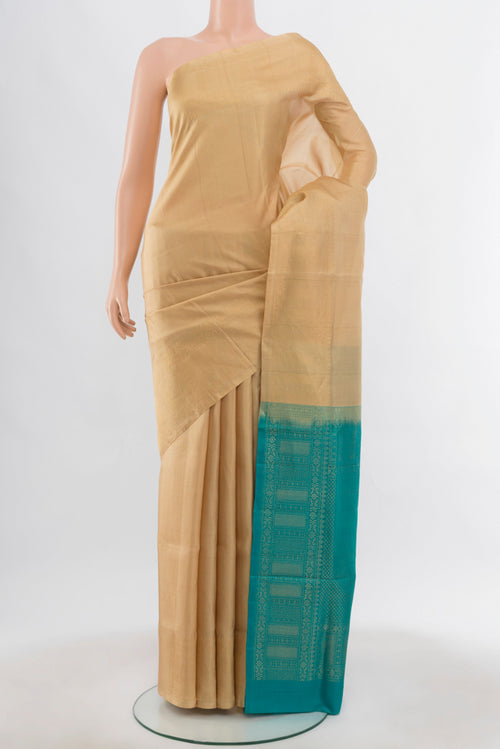 Beige Soft Silk Saree with Zari Butta on the body and Silk Border.  displayed on a mannequin