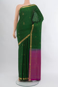 Bottle Green Soft Silk Saree with Zari Butta on the body and Silk Border.  displayed on a mannequin