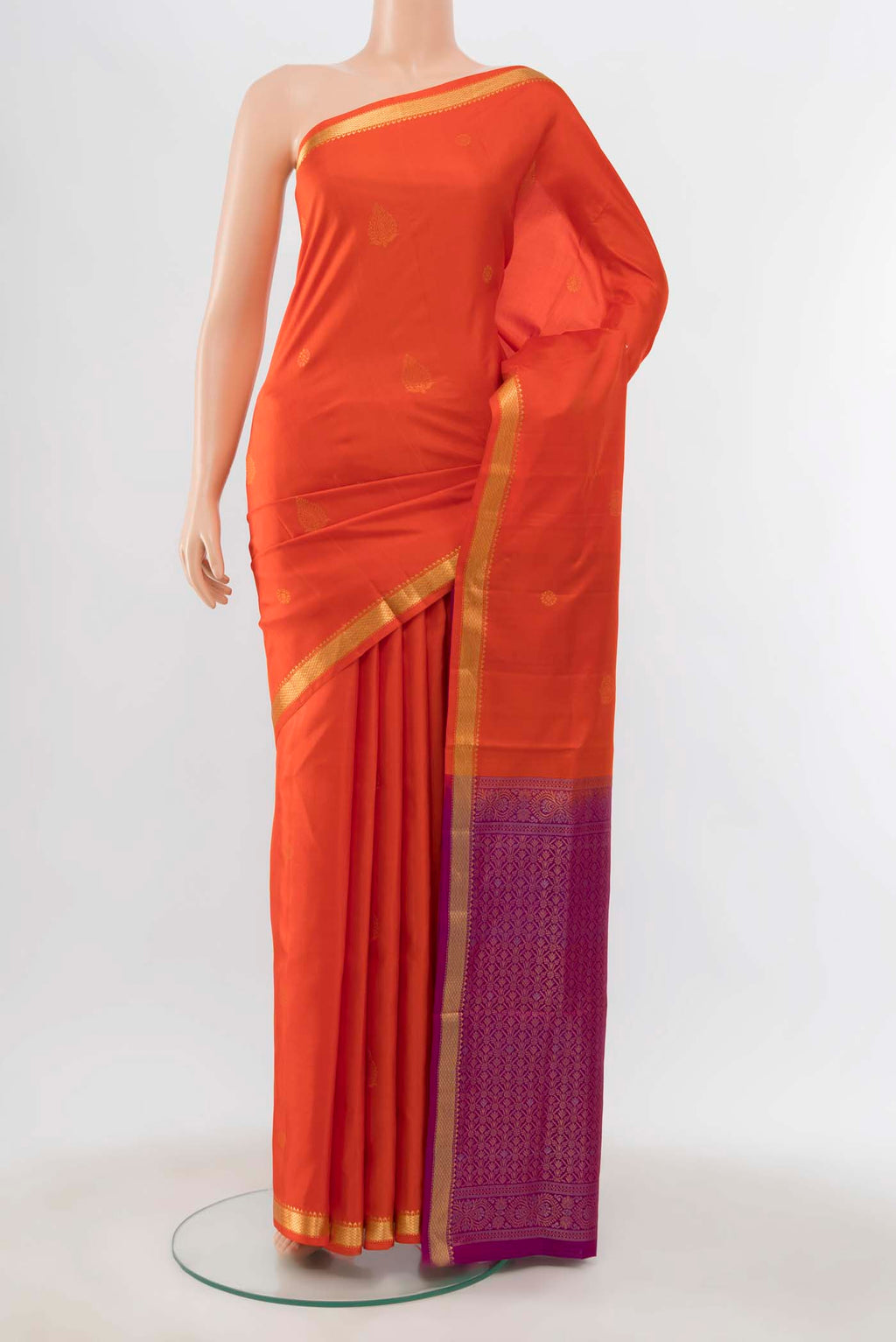 Orange Soft Silk Saree with Zari Butta on the body and Silk Border displayed on a mannequin