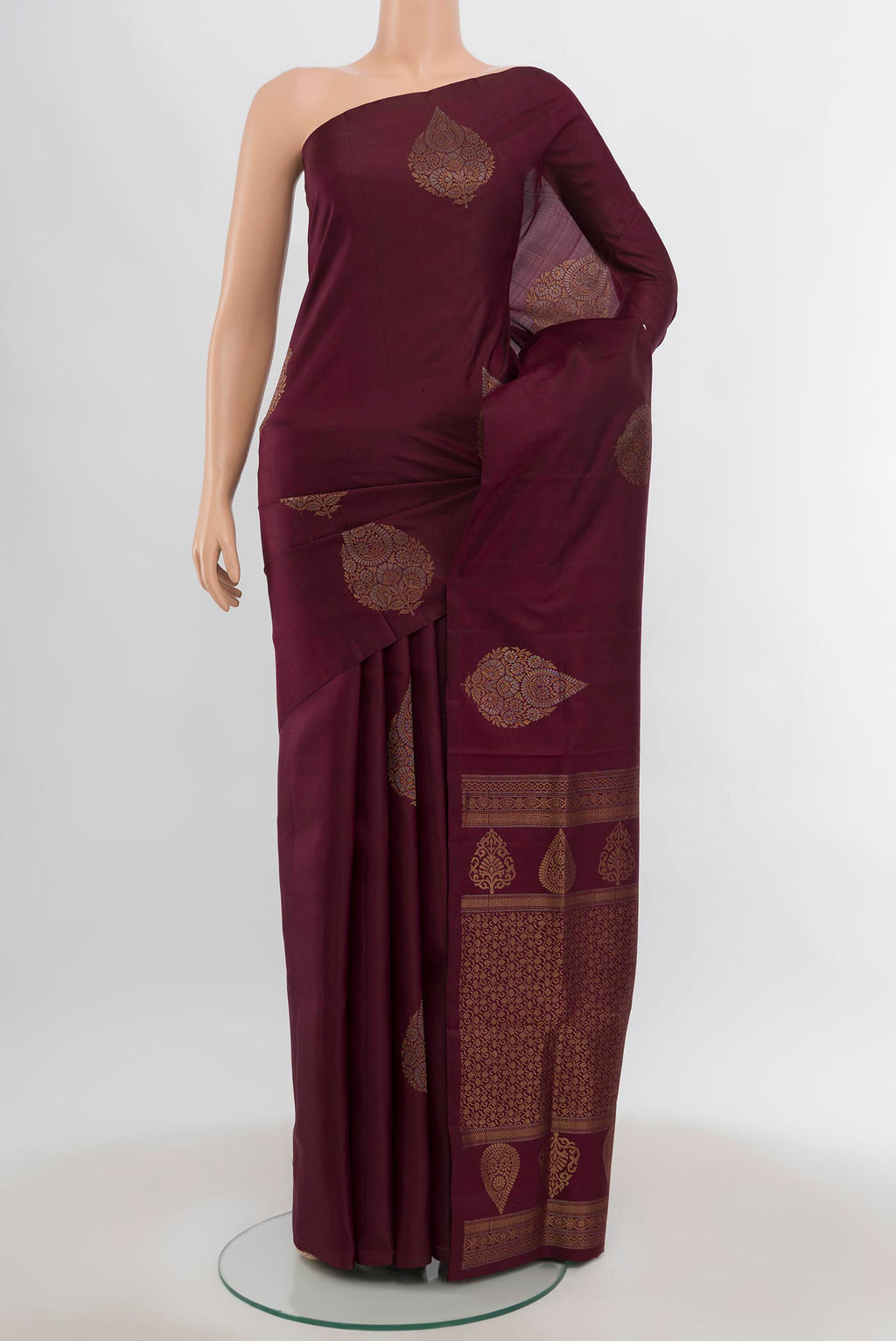 Coffee Brown Soft Silk Saree with Zari Butta on the body and Silk Border.  displayed on a mannequin