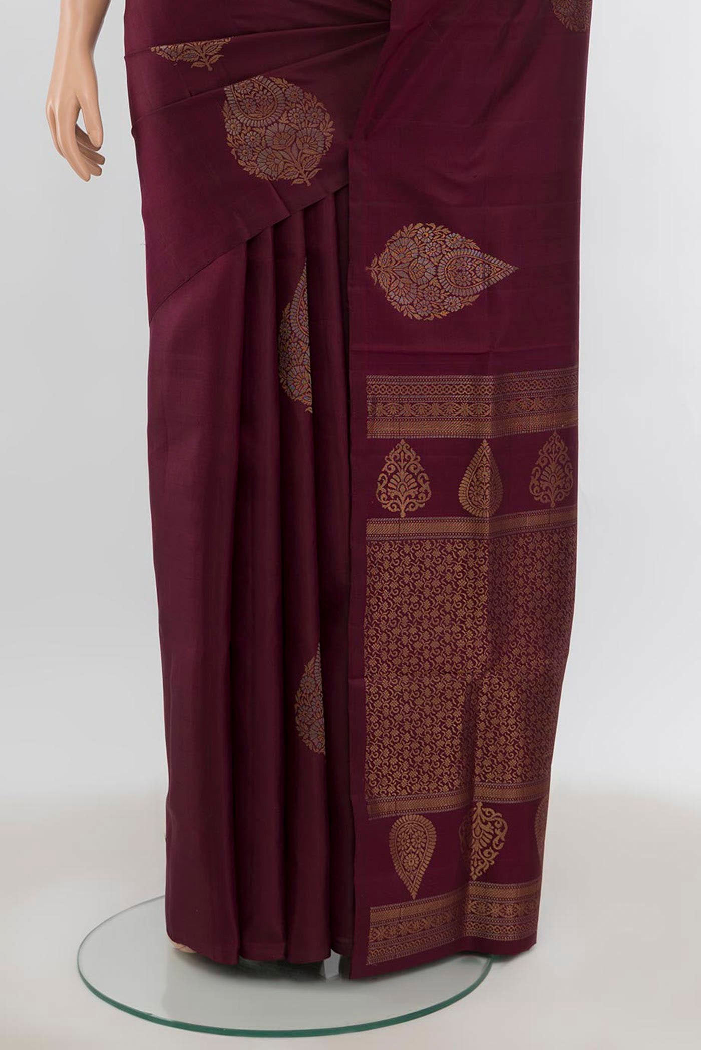 Pleats and pallu of Coffee Brown Soft Silk Saree with Zari Butta on the body and Silk Border. 