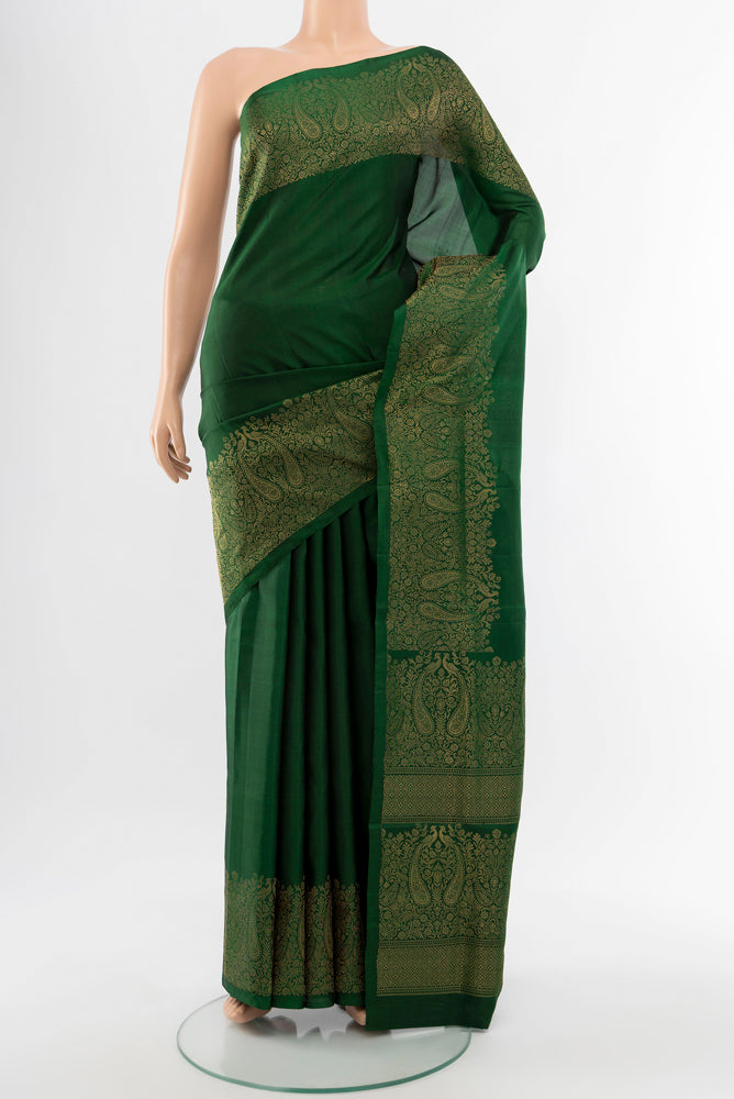 Bottle Green Soft Silk Saree with Zari Butta on the body and Silk Border.  displayed on a mannequin