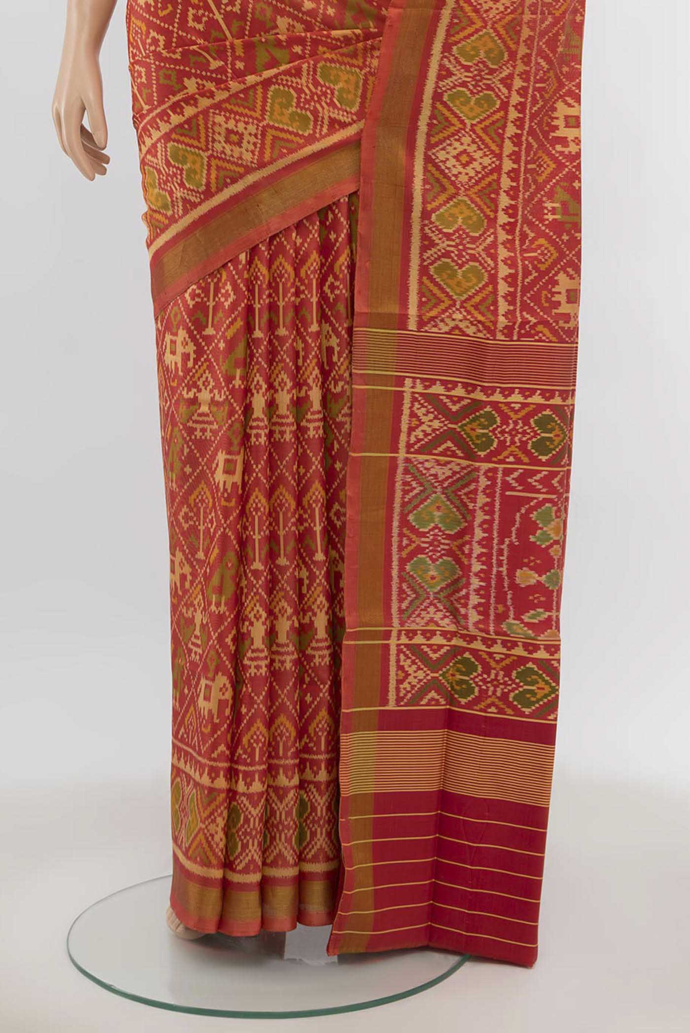 Pleats and pallu of Peach Rajkot Patola Silk Saree with Zari Butta on the body and Silk Border. 