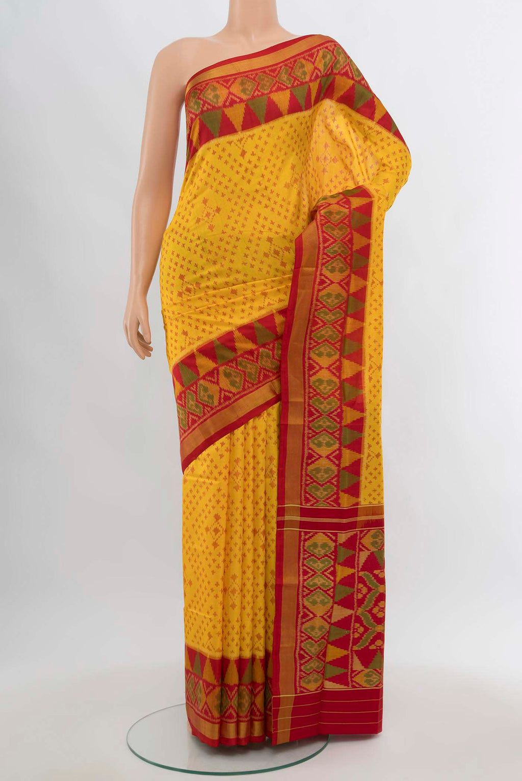 Yellow Rajkot Patola Silk Saree with Ikat Print on the body and Silk Border.  displayed on a mannequin
