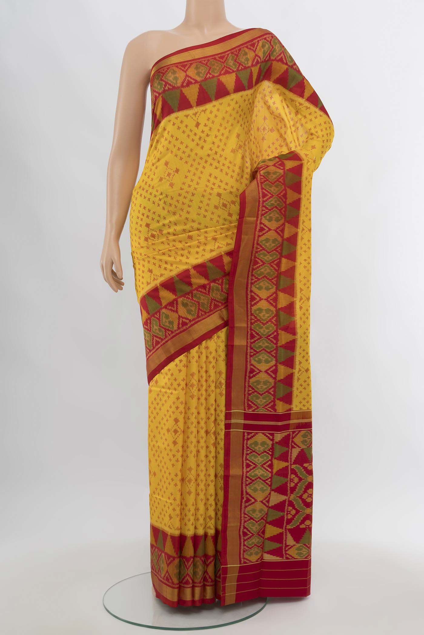 Yellow Rajkot Patola Silk Saree with Ikat Print on the body and Silk Border.  displayed on a mannequin