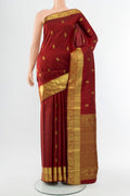 Maroon Kanchipuram Silk Saree with Zari Butta on the body and Silk Border.  displayed on a mannequin