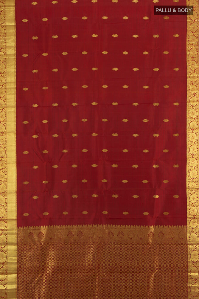 Flat view of Maroon Kanchipuram Silk Saree with Zari Butta on the body and Silk Border. 