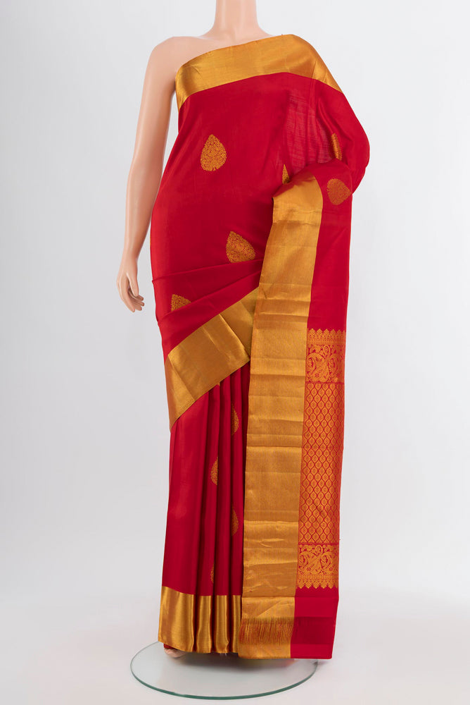 Red Kanchipuram Silk Saree with Zari Butta on the body and Silk Border.  displayed on a mannequin