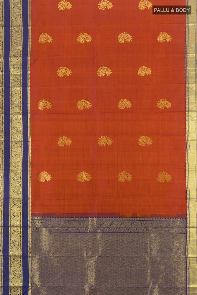 Flat view of Pure Silk Pure Zari Rust Kanchipuram Saree with Zari Butta on the body and Silk Border. 