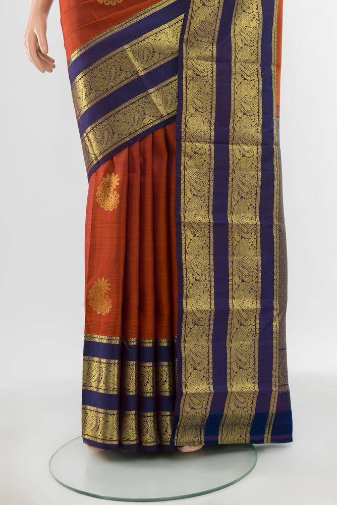 Pleats and pallu of Pure Silk Pure Zari Rust Kanchipuram Saree with Zari Butta on the body and Silk Border. 