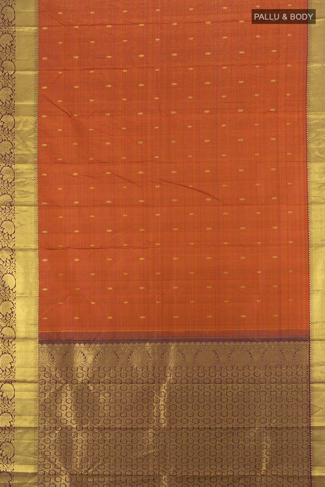 Flat view of Pure Silk Pure Zari Rust Kanchipuram Saree with Zari Butta on the body and Silk Border. 
