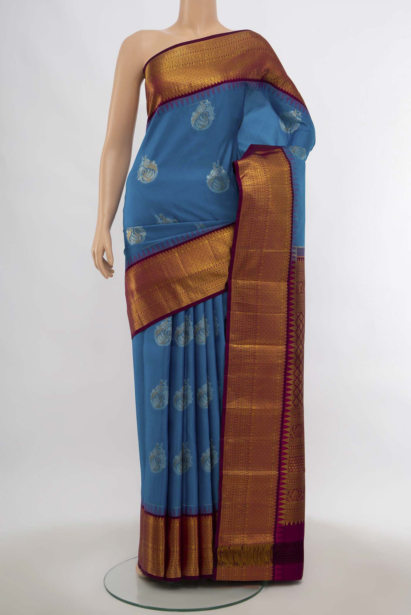 Dark Blue Kanjivaram Silk Saree with Zari Butta on the body and Silk Border.  displayed on a mannequin