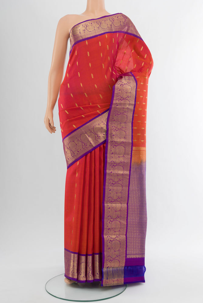 Pure Silk Pure Zari Peach Kanchipuram Saree with Zari Butta on the body and Silk Border.  displayed on a mannequin