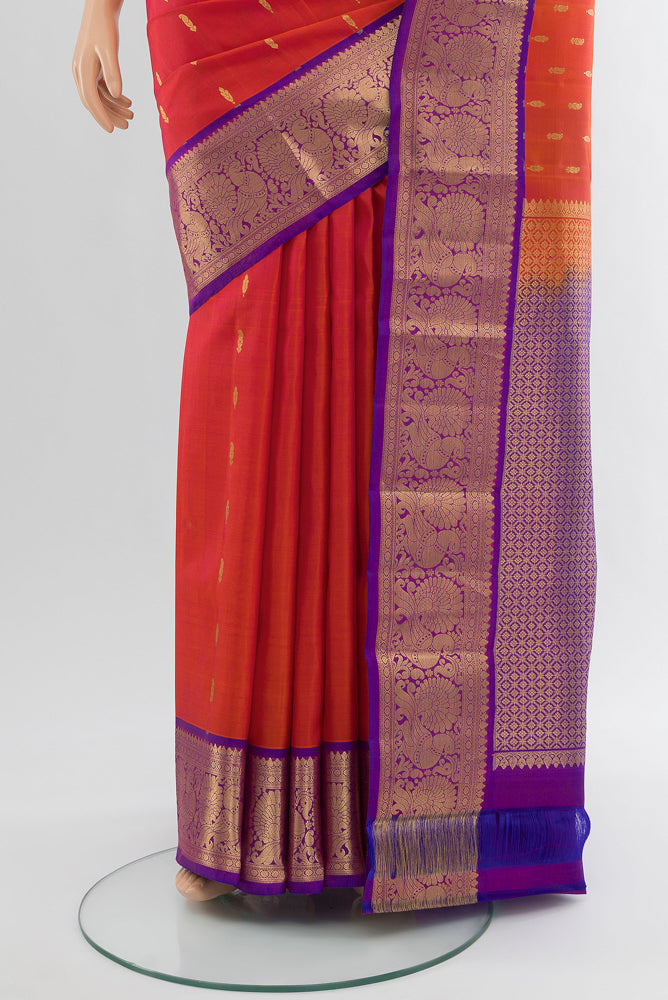 Pleats and pallu of Pure Silk Pure Zari Peach Kanchipuram Saree with Zari Butta on the body and Silk Border. 