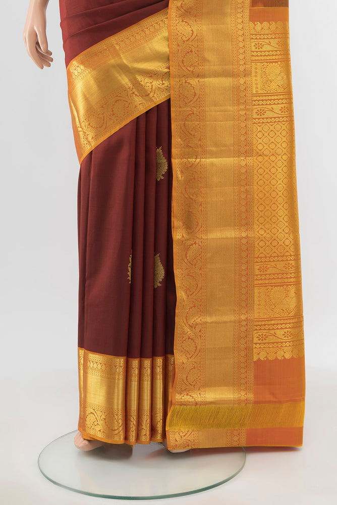 Pleats and pallu of Pure Silk Pure Zari Maroon Kanchipuram Saree with Zari Butta on the body and Silk Border. 