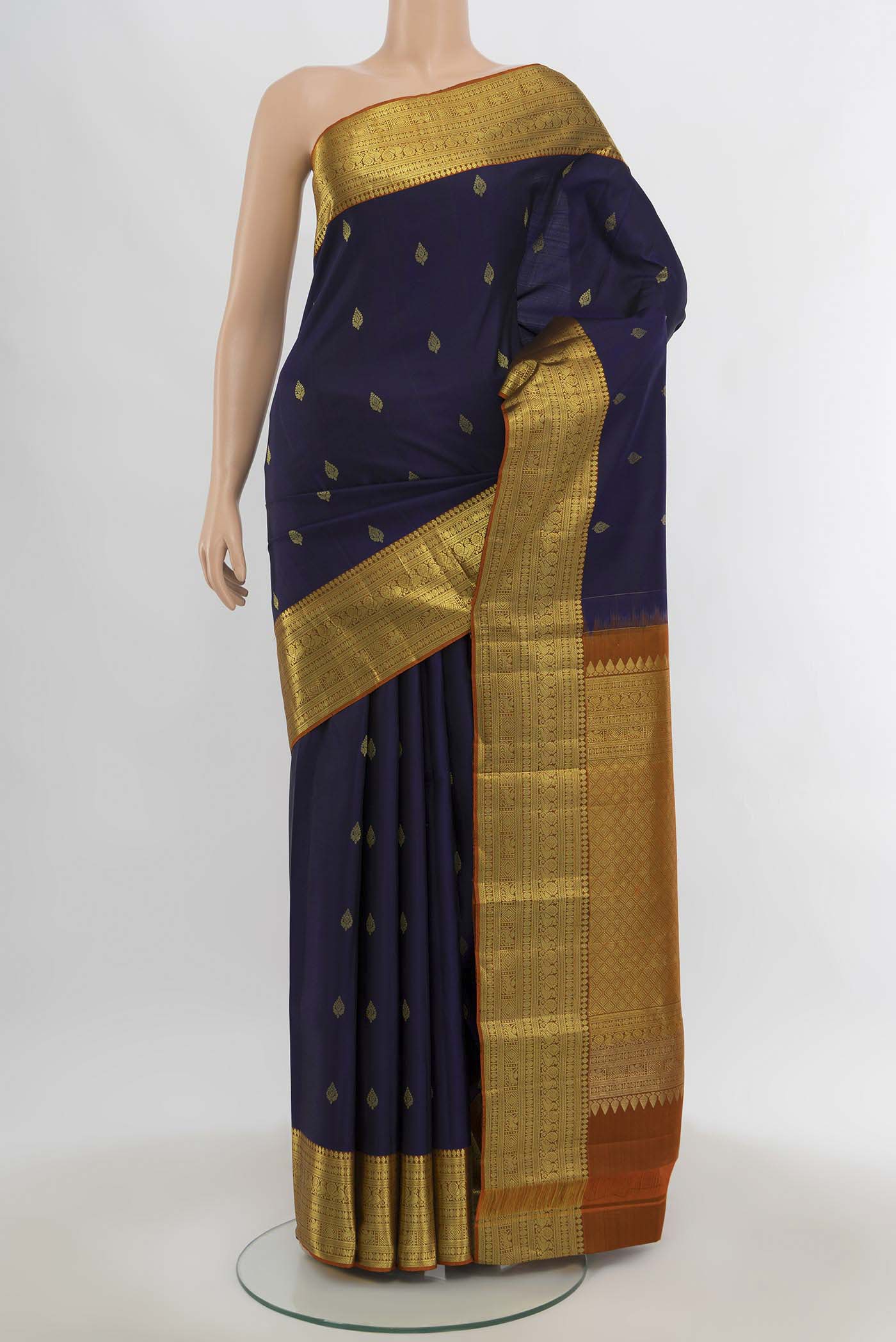 Navy Blue Kanchipuram Silk Saree with Zari Butta on the body and Silk Border.  displayed on a mannequin