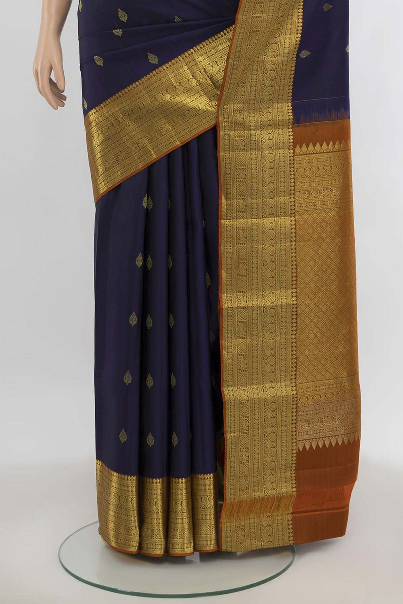 Pleats and pallu of Navy Blue Kanchipuram Silk Saree with Zari Butta on the body and Silk Border. 