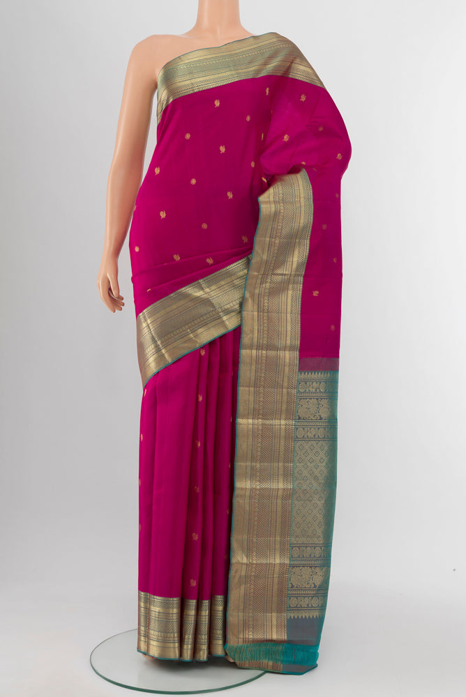Rani Pink Kanchipuram Silk Saree with Zari Butta on the body and Silk Border.  displayed on a mannequin