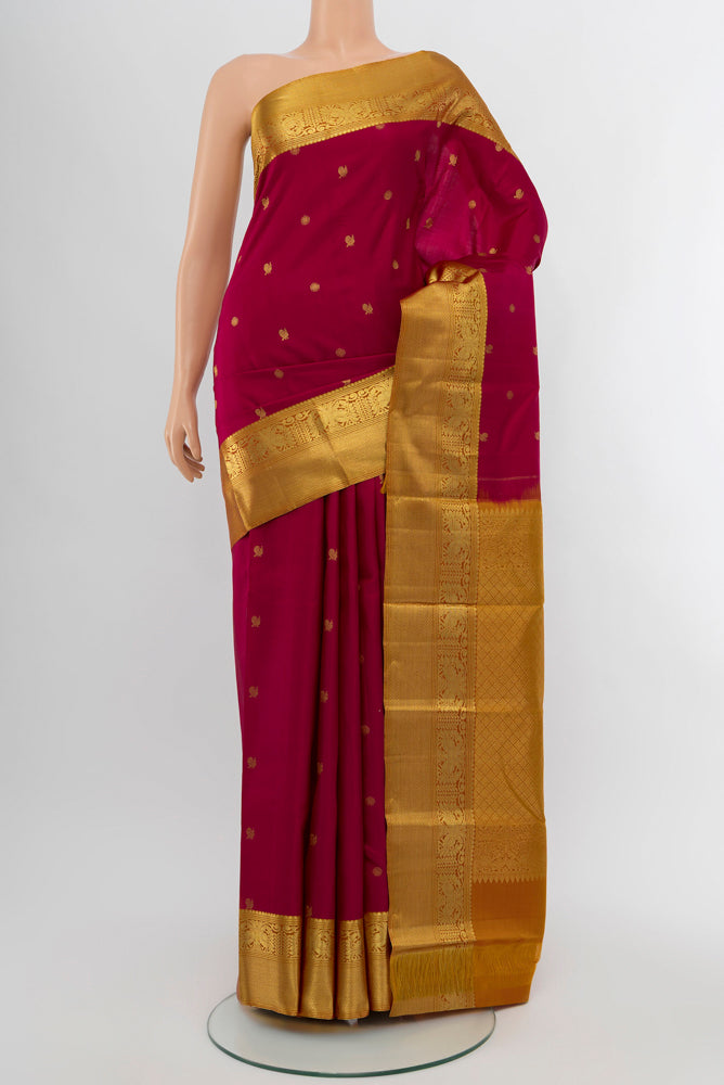 Dark Pink Kanchipuram Silk Saree with Zari Butta on the body and Silk Border.  displayed on a mannequin